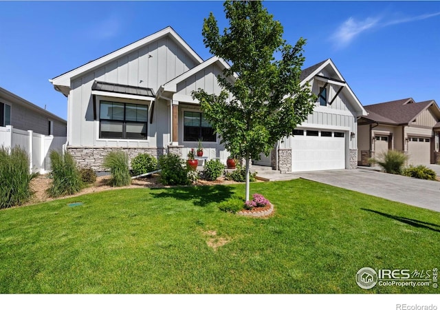4521 Devereux Dr, Windsor, CO 80550 - view of front of home with board and batten siding, stone siding, driveway, and a garage