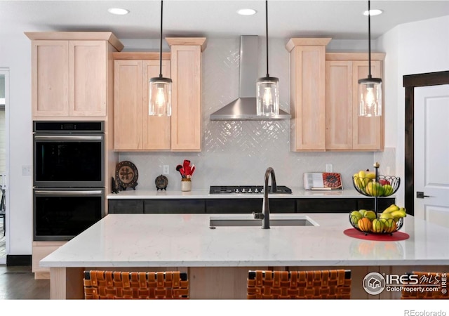 4521 Devereux Dr, Windsor, CO 80550 - kitchen featuring double oven, wall chimney exhaust hood, light brown cabinetry, and recessed lighting