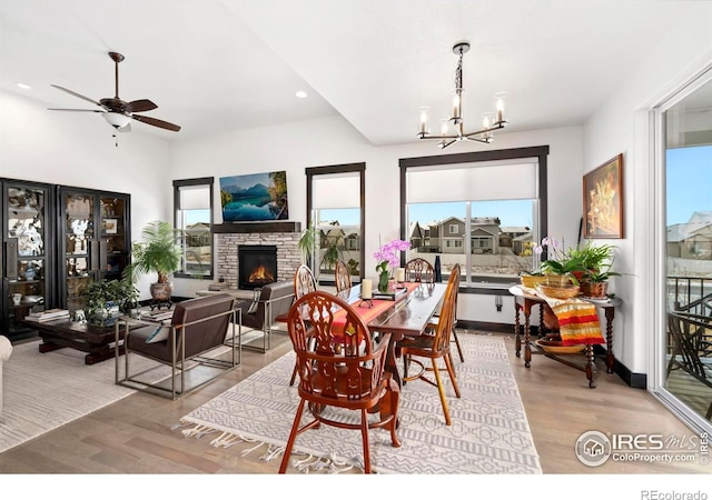 4521 Devereux Dr, Windsor, CO 80550 - dining area with wood finished floors, healthy amount of natural light, a fireplace, a chandelier, and recessed lighting
