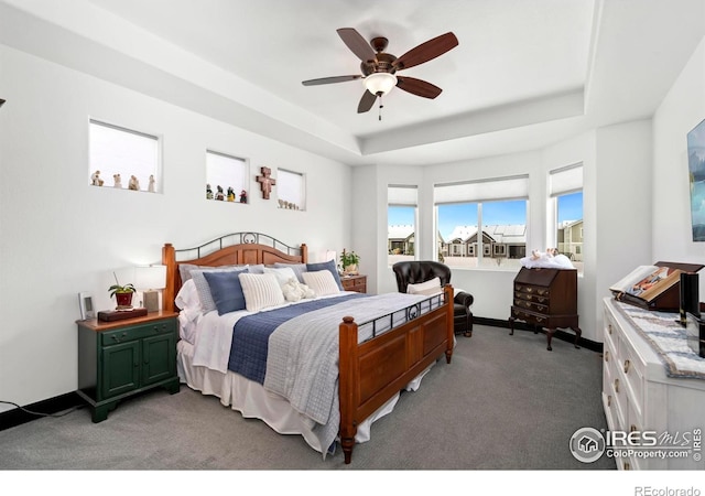 4521 Devereux Dr, Windsor, CO 80550 - carpeted bedroom featuring a tray ceiling and a ceiling fan