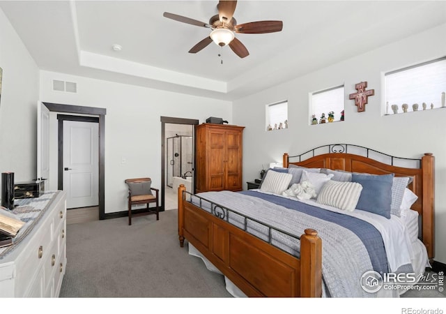 4521 Devereux Dr, Windsor, CO 80550 - bedroom featuring a raised ceiling, light colored carpet, and a ceiling fan