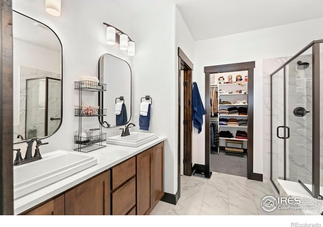 4521 Devereux Dr, Windsor, CO 80550 - bathroom featuring marble look tiles, a stall shower, a walk in closet, and double vanity