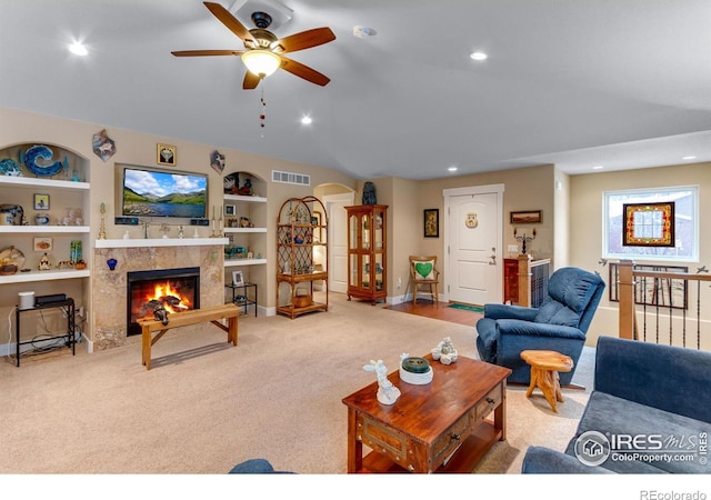 2126 Friar Tuck Ct, Fort Collins, CO 80524 - carpeted living area with a ceiling fan, a tile fireplace, built in shelves, recessed lighting, and baseboards