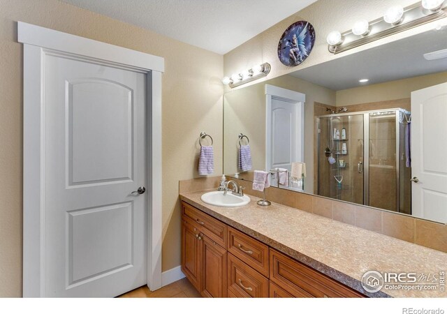 2126 Friar Tuck Ct, Fort Collins, CO 80524 - bathroom with a stall shower, vanity, and tile patterned floors