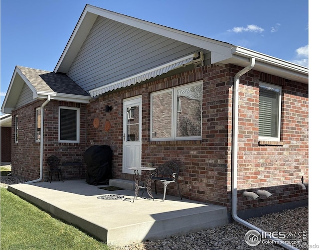 2126 Friar Tuck Ct, Fort Collins, CO 80524 - back of house with brick siding and a shingled roof