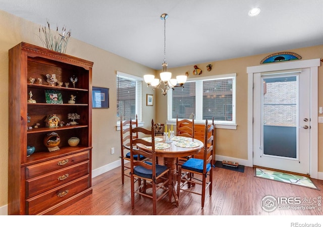 2126 Friar Tuck Ct, Fort Collins, CO 80524 - dining space with a chandelier, baseboards, and light wood-style flooring
