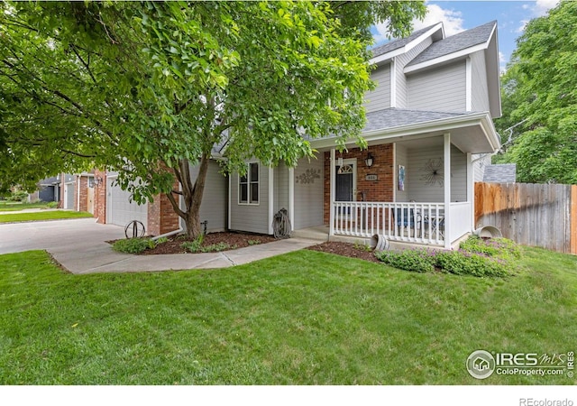 806 51st Ave, Greeley, CO 80634 - view of front of home featuring a porch, concrete driveway, roof with shingles, and a garage