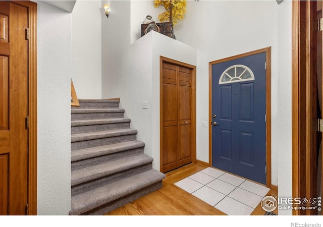 806 51st Ave, Greeley, CO 80634 - foyer entrance with stairs, light wood finished floors, and a towering ceiling