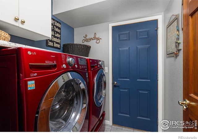 806 51st Ave, Greeley, CO 80634 - washroom featuring washer and clothes dryer, cabinet space, and tile patterned floors