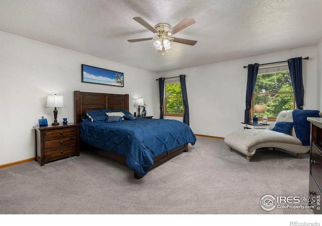 806 51st Ave, Greeley, CO 80634 - carpeted bedroom featuring multiple windows, a textured ceiling, and a ceiling fan