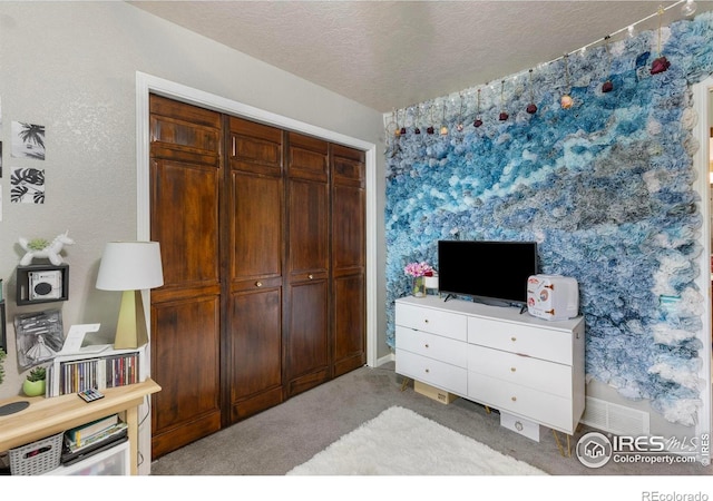 806 51st Ave, Greeley, CO 80634 - bedroom with light colored carpet, a textured ceiling, and a closet