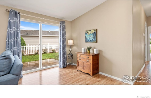 856 Sunchase Dr, Fort Collins, CO 80524 - entryway featuring light wood-style flooring, baseboards, vaulted ceiling, and healthy amount of natural light