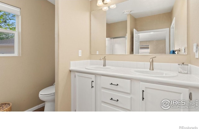 856 Sunchase Dr, Fort Collins, CO 80524 - bathroom with double vanity, toilet, and a shower with shower door