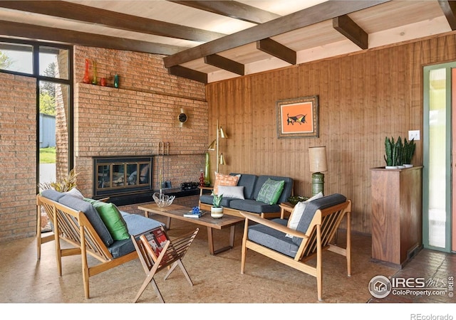 5450 Mohawk Rd, Littleton, CO 80123 - living area featuring beamed ceiling, a fireplace, and brick wall