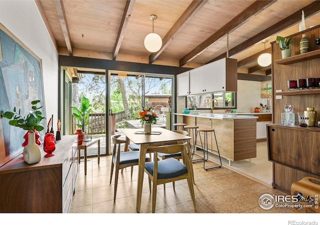 5450 Mohawk Rd, Littleton, CO 80123 - dining room featuring wooden ceiling with exposed beams and light floors