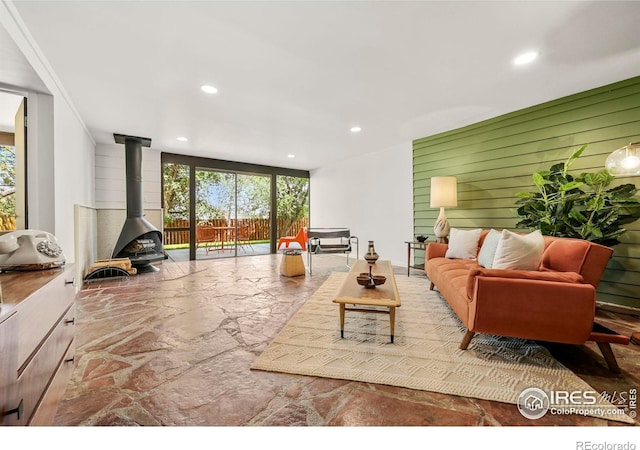 5450 Mohawk Rd, Littleton, CO 80123 - living room with stone floors, recessed lighting, a wood stove, and wooden walls