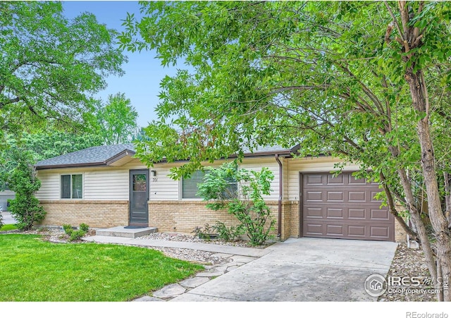 701 Elm St, Windsor, CO 80550 - view of front of property with brick siding, an attached garage, concrete driveway, and a front lawn