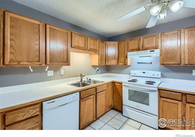 701 Elm St, Windsor, CO 80550 - kitchen with white appliances, a sink, under cabinet range hood, a textured ceiling, and light countertops