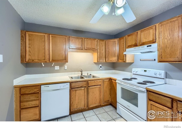 701 Elm St, Windsor, CO 80550 - kitchen with under cabinet range hood, white appliances, a sink, ceiling fan, and light countertops