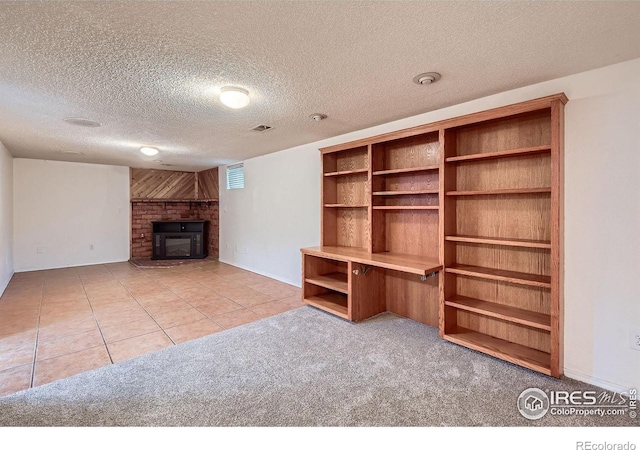 701 Elm St, Windsor, CO 80550 - unfurnished living room with a brick fireplace, a textured ceiling, tile patterned floors, baseboards, and carpet flooring