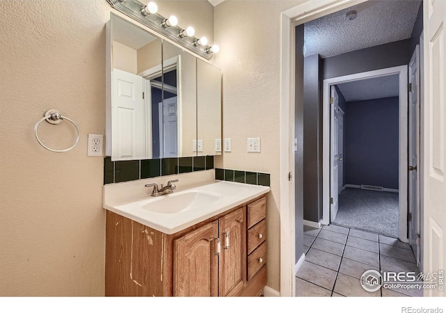 701 Elm St, Windsor, CO 80550 - bathroom featuring vanity, tile patterned flooring, and a textured wall