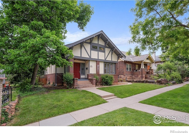 1020 10th St, Boulder, CO 80302 - english style home featuring stucco siding, brick siding, and a front yard