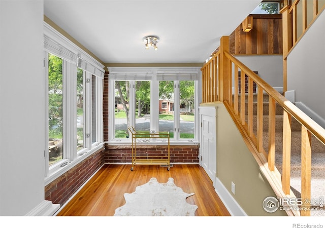 1020 10th St, Boulder, CO 80302 - unfurnished sunroom featuring healthy amount of natural light, wood finished floors, and brick wall