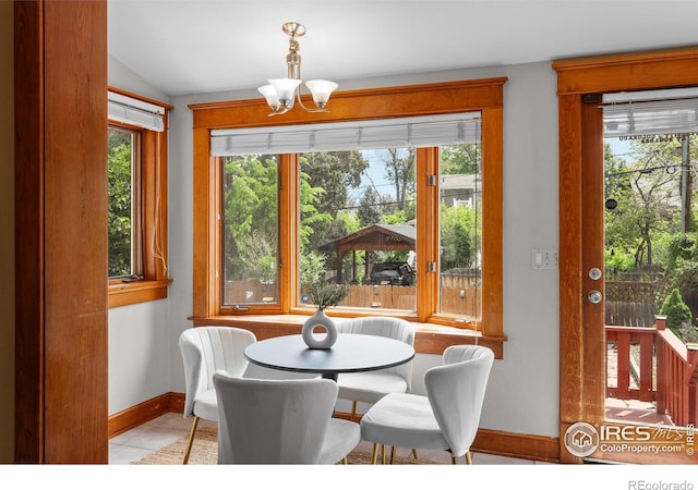 1020 10th St, Boulder, CO 80302 - tiled dining room with baseboards, a chandelier, and lofted ceiling