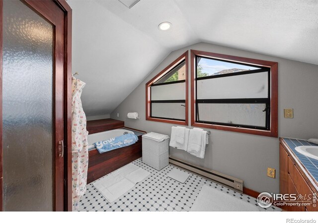 1020 10th St, Boulder, CO 80302 - full bathroom with a baseboard heating unit, lofted ceiling, vanity, a garden tub, and tile patterned floors