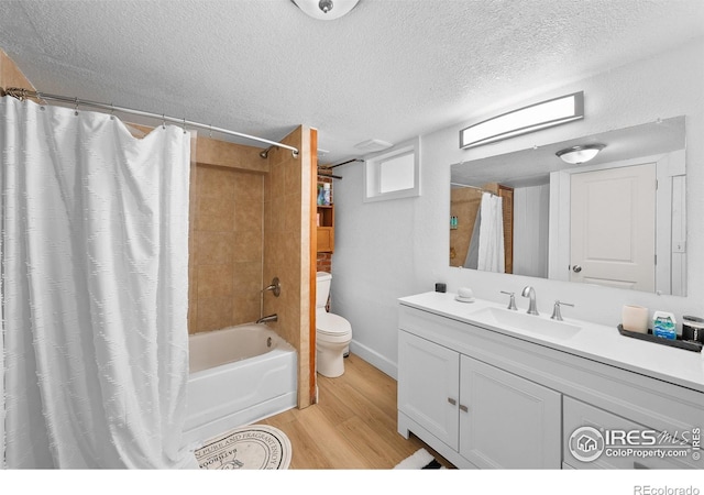 1020 10th St, Boulder, CO 80302 - full bath featuring wood finished floors, toilet, vanity, shower / bath combination with curtain, and a textured ceiling