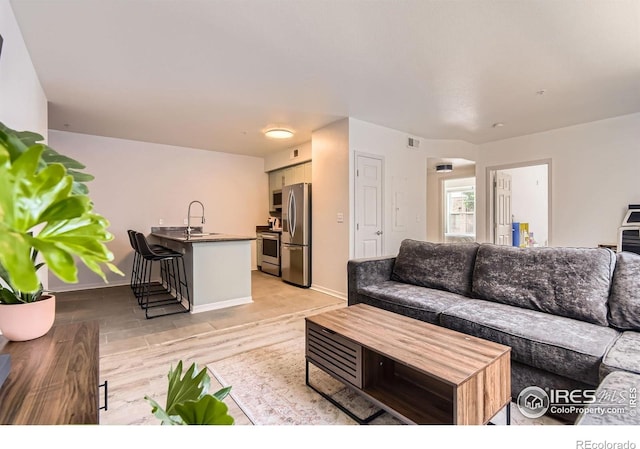 1623 Saint Paul St Unit 310, Denver, CO 80206 - living area with light wood-style flooring and baseboards