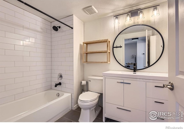 1623 Saint Paul St Unit 310, Denver, CO 80206 - full bathroom featuring toilet, vanity,  shower combination, tile patterned flooring, and a textured ceiling