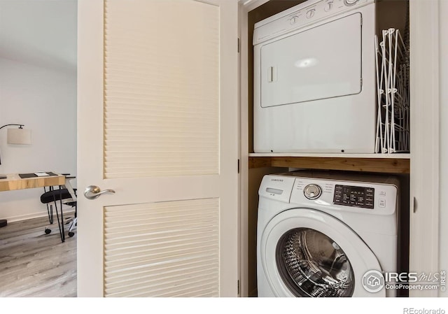 1623 Saint Paul St Unit 310, Denver, CO 80206 - washroom with stacked washer / dryer and wood finished floors
