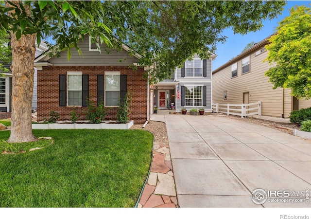 1706 Naples Ln, Longmont, CO 80503 - view of front facade featuring brick siding and driveway