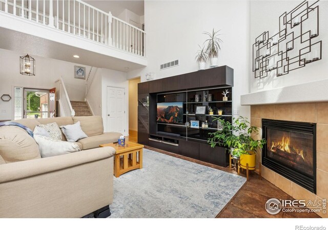 1706 Naples Ln, Longmont, CO 80503 - living room featuring a high ceiling, stairs, and a fireplace
