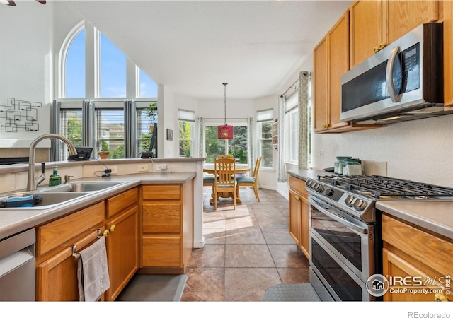 1706 Naples Ln, Longmont, CO 80503 - kitchen with appliances with stainless steel finishes, a sink, light countertops, and baseboards