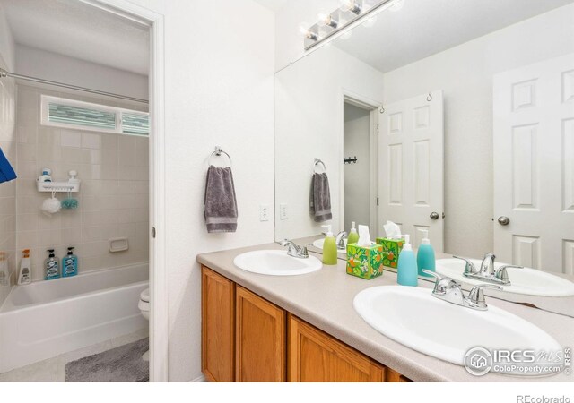 1706 Naples Ln, Longmont, CO 80503 - full bathroom featuring double vanity, toilet, tile patterned floors, and tub / shower combination