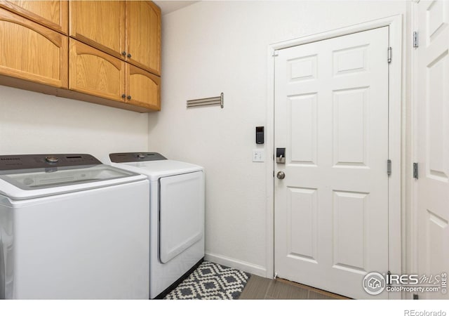 1706 Naples Ln, Longmont, CO 80503 - laundry area with cabinet space, separate washer and dryer, and baseboards