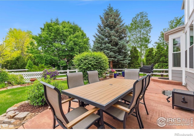 1706 Naples Ln, Longmont, CO 80503 - view of patio / terrace with outdoor dining space and view of wooded area