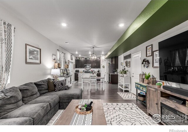 10 N Quantock St, Aurora, CO 80018 - living room with dark wood-style floors, recessed lighting, and a chandelier