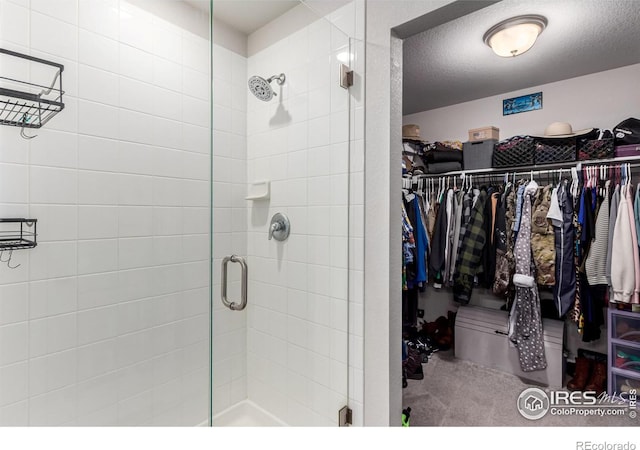 10 N Quantock St, Aurora, CO 80018 - bathroom featuring a stall shower and a walk in closet