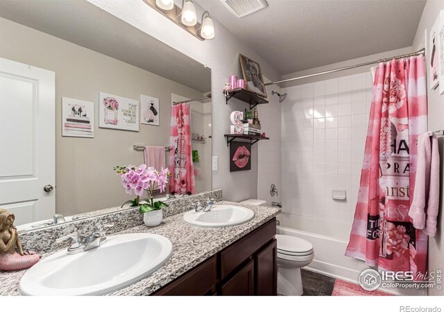 10 N Quantock St, Aurora, CO 80018 - bathroom with toilet, double vanity, shower / tub combo, and tile patterned flooring