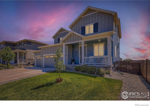10 N Quantock St, Aurora, CO 80018 - view of front facade featuring board and batten siding, a porch, driveway, and an attached garage