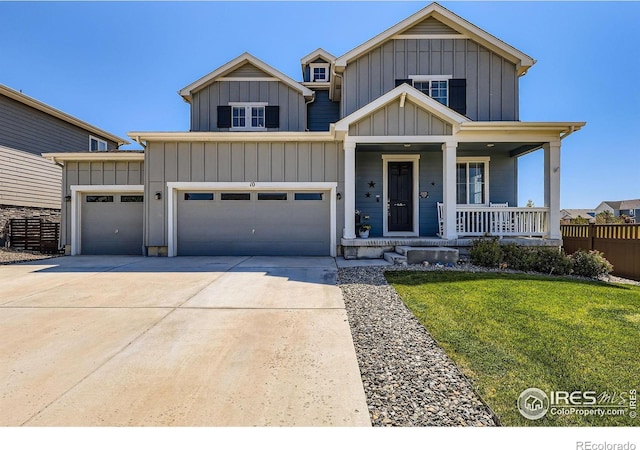 10 N Quantock St, Aurora, CO 80018 - view of front of home featuring a porch, concrete driveway, board and batten siding, and an attached garage