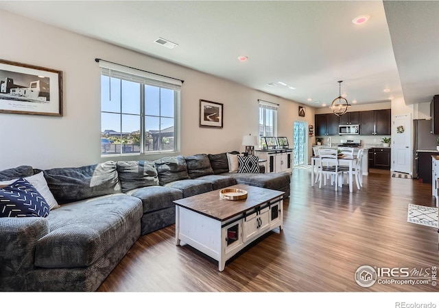 10 N Quantock St, Aurora, CO 80018 - living area with dark wood-style floors, a chandelier, and recessed lighting