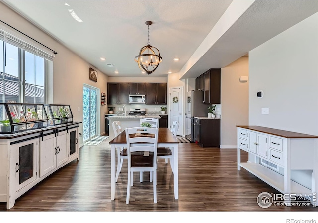 10 N Quantock St, Aurora, CO 80018 - dining space featuring a chandelier, dark wood-style floors, and recessed lighting