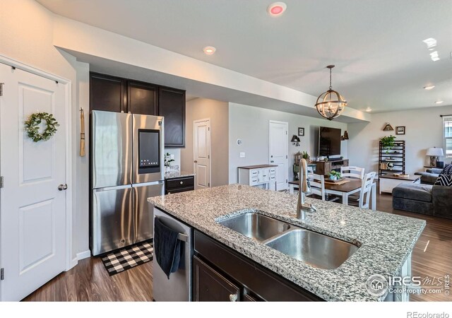 10 N Quantock St, Aurora, CO 80018 - kitchen featuring appliances with stainless steel finishes, dark wood-type flooring, open floor plan, a chandelier, and recessed lighting