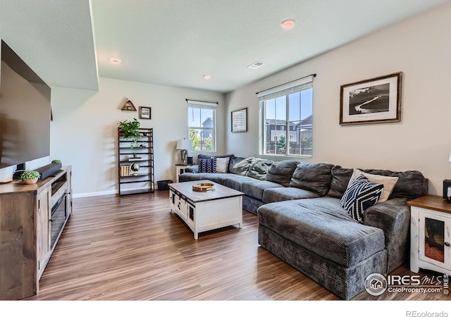 10 N Quantock St, Aurora, CO 80018 - living room featuring wood finished floors and recessed lighting