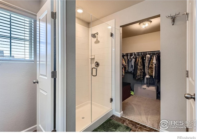 10 N Quantock St, Aurora, CO 80018 - full bathroom with a stall shower, a spacious closet, and tile patterned floors