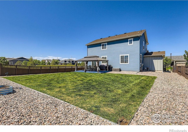 10 N Quantock St, Aurora, CO 80018 - back of house featuring a gazebo, a patio, and a fenced backyard